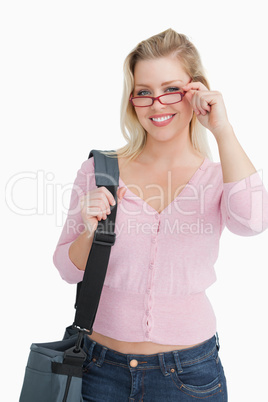 Smiling blonde woman wearing red glasses