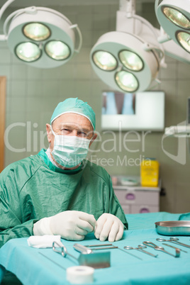 Surgeon sitting in front of surgical tools