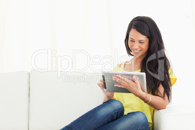 Beautiful smiling Latino using a touch pad