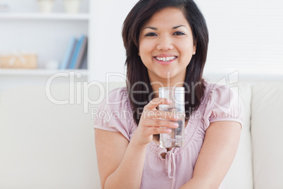Woman holding a glass full of water