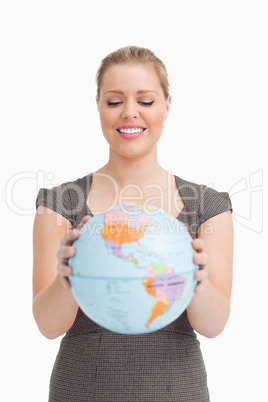Pretty woman showing a globe