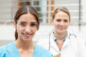 Smiling nurse and doctor standing