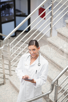 High angle view of a doctor touching a tablet computer