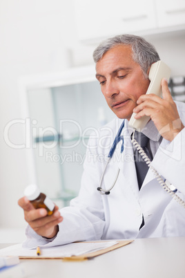 Doctor holding a phone and drug box
