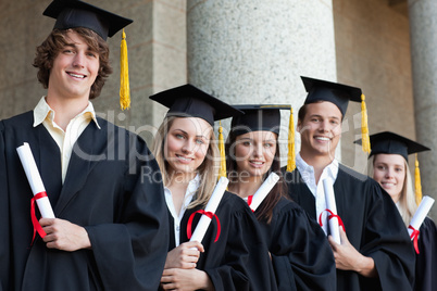 Close-up of five graduates students posing