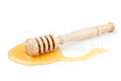 Honey dipper on the floor spilling honey