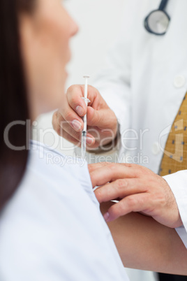 Close up of a doctor doing an injection to a patient