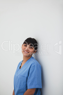Female nurse leaning on the wall