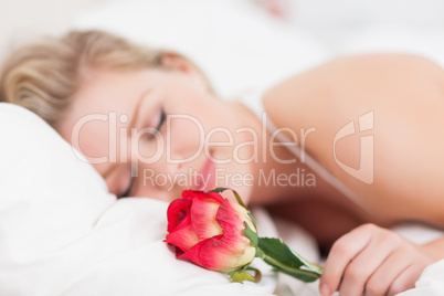 Young woman with a rose sleeping