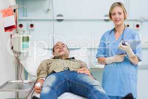 Nurse next to a male transfused patient