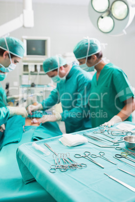 Surgical tools on a surgical tray while surgeons are operating