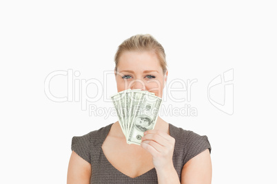 Woman hiding her mouse with dollars banknotes