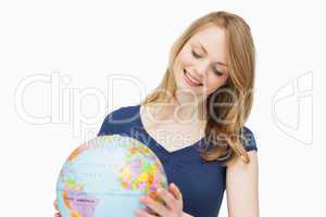 Woman holding a globe while smiling