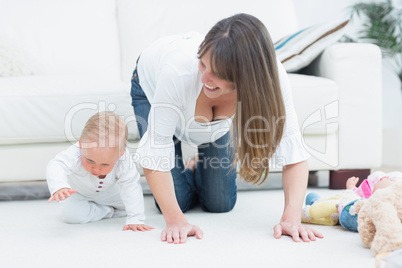 Mother on all fours next to a baby