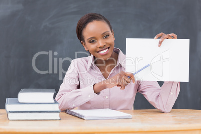 Black teacher holding a blank paper while showing it
