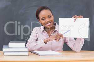 Black teacher holding a blank paper while showing it