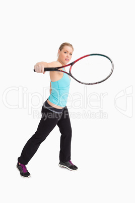 Woman playing tennis with a racket