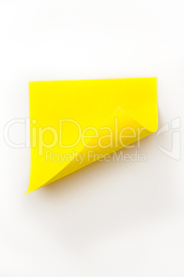 Close up of a yellow curved adhesive note