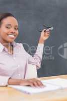 Teacher showing the blackboard with her glasses