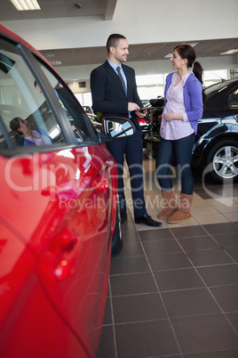 Woman smiles as she talks with a salesman