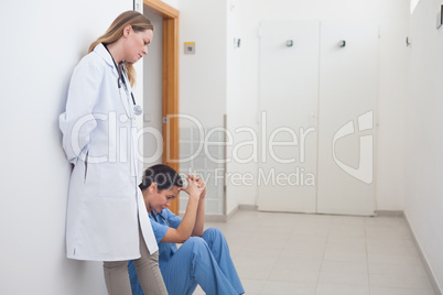 Doctor standing next to a nurse