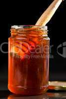 Honey full jar with a honey dipper