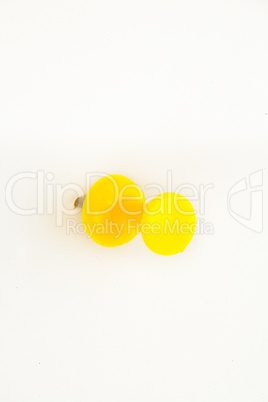 Close up of a yellow pushpin pierced in the wall