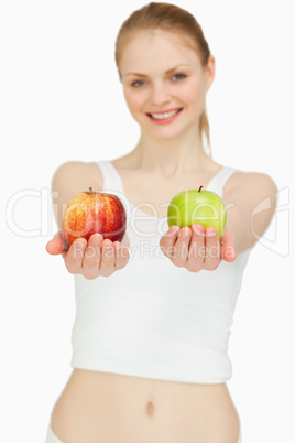 Cheerful woman presenting two apples