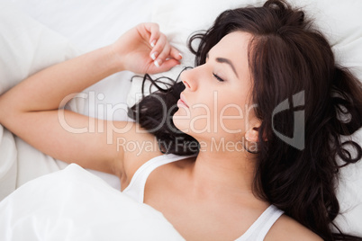 Brown-haired woman sleeping in the morning