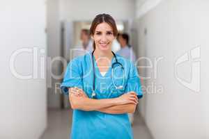 Smiling nurse folding her arms while standing