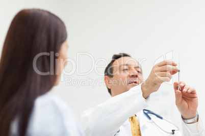 Doctor checking an injection for a patient