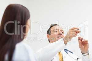 Doctor checking an injection for a patient