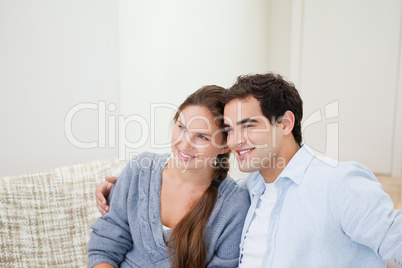 Couple smiling while hugging each other