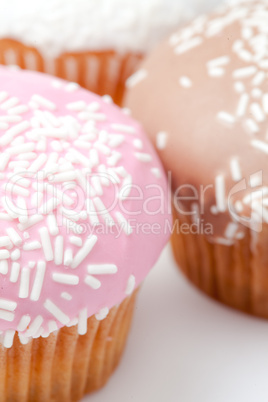 Extreme close up of many muffins with icing sugar