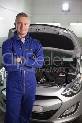 Mechanic standing while looking at camera