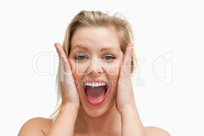 Happy blonde woman standing while showing her surprise