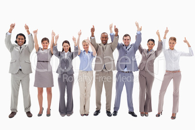Business team raising their arms with the thumbs up