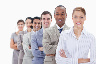 Close-up of smiling colleagues dressed in suits crossing their a