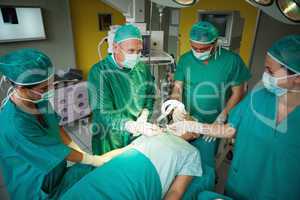 Smiling surgeon taking a scalpel