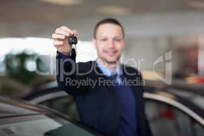 Dealer standing while holding car keys