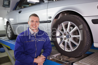 Man looking at camera next to a car