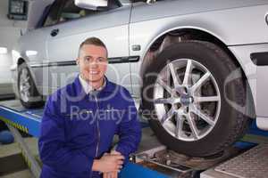 Man looking at camera next to a car