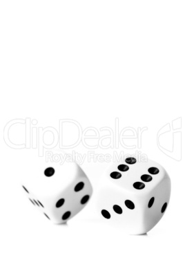 Two black and white dices in motion