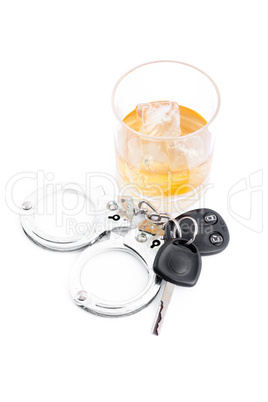 Car key next to a whiskey and a handcuff