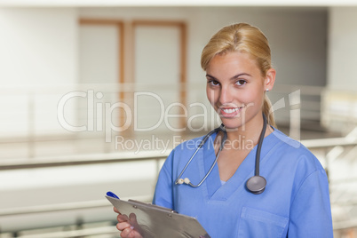 Blonde nurse holding a clipboard