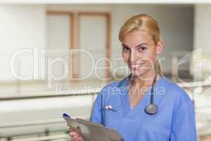 Blonde nurse holding a clipboard