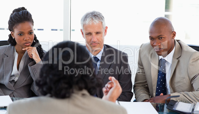A business team is earnestly listening to an associate