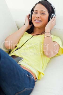 High-angle view of a young Latino listening music on a smartphon