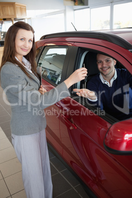 Man tending his hand while receiving car keys