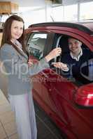 Man tending his hand while receiving car keys